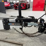 Shocker friction sway control arm connecting a clamp-on aluminum trailer frame bracket to a hitch-side sway ball.