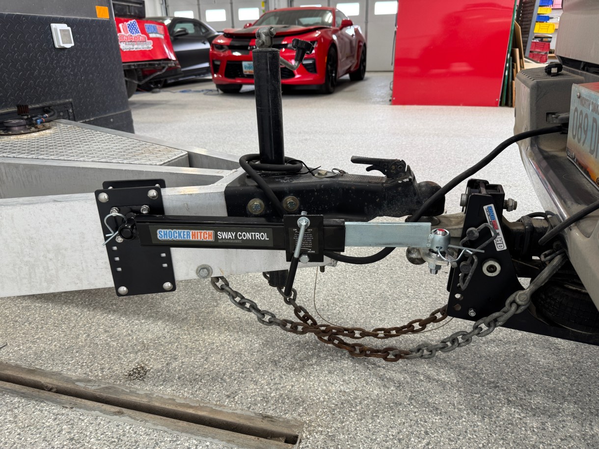 Shocker friction sway control arm connecting a clamp-on aluminum trailer frame bracket to a hitch-side sway ball.