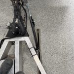 Overhead view of one Shocker sway arm mounted outside an aluminum trailer A-frame rail with an SH-7010 clamp bracket.