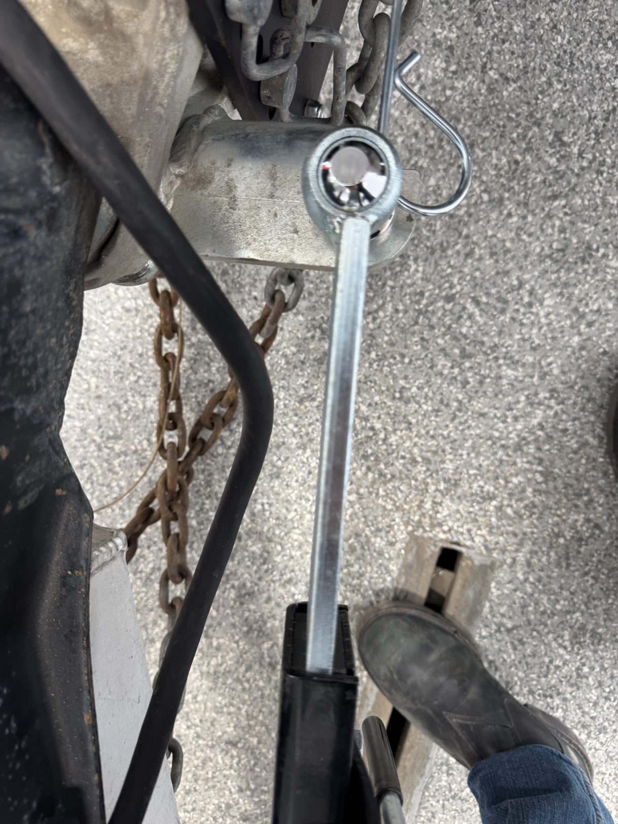 Close-up of the silver Shocker sway arm socket fitted over the hitch-side mini ball with its retaining clip.
