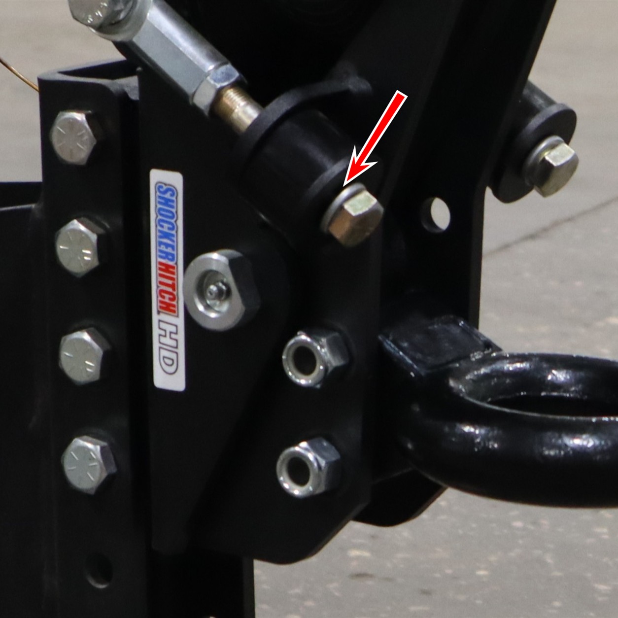 Arrow pointing to the top of the washer between the bolt head and bump cushion on a Shocker Air Tongue Mount