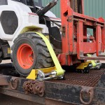 Skid Steer Front Wheels Strapped on Trailer