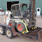Skid Steer Strapped on Trailer
